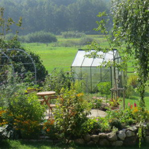 Green house at the bottom of a garden