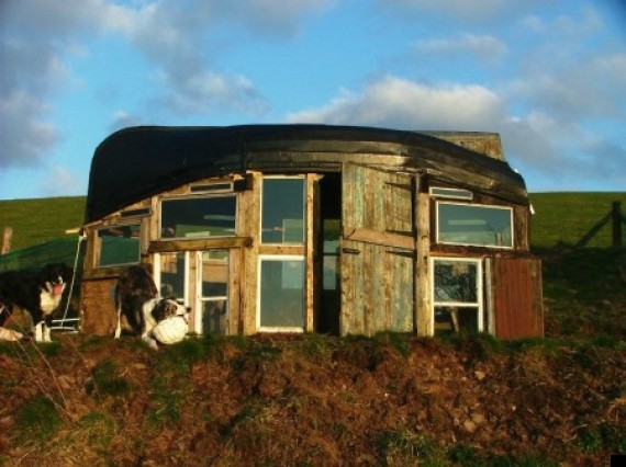 upside down boat and old window panes make this shed